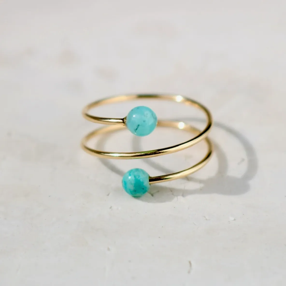 Gold spiral ring with turquoise beads.